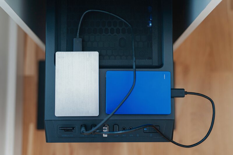 Two external drives cabled to a desktop computer, seen from above.